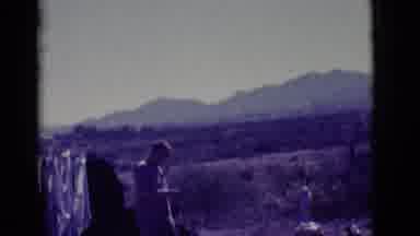 Clarkdale Arizona (1966): Man Wearing Grey Shirt Gives German Shepherd Dog Treat