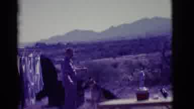 Clarkdale Arizona (1966): Man Standing Next To Clothesline Playing With Dog Cuts