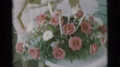 Clarkdale Arizona (1966): A Bouquet Of Red And White Flowers Is Being Moved Gently