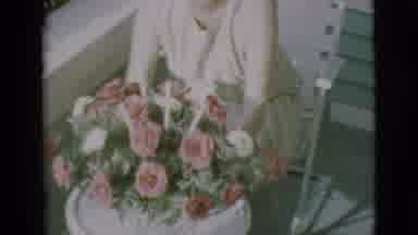 Clarkdale Arizona (1966): A Lady Sits Rotating A Nice Bouquet Of Flowers On A