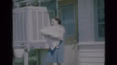 Clarkdale Arizona (1966): Woman Stands Outside House Holding Blanket Or Bedding