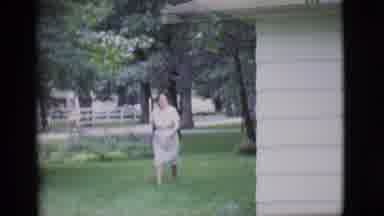 Clarkdale Arizona (1966): A Woman Carries A Rake In Hand As She Walks Along The