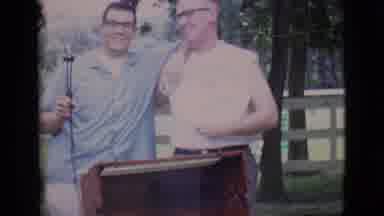 Clarkdale Arizona (1966): Two Men Stand Behind Barbeque Grill With Roast Turning