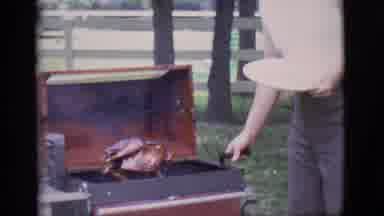 Clarkdale Arizona (1966): Man Wearing White Shirt Lifts Roasted Turkey Out Of