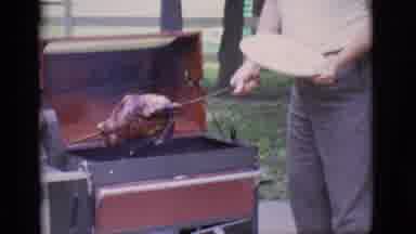 Clarkdale Arizona (1966): A Man Is Outside Pulling A Large Turkey Off Of The Grill