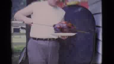 Clarkdale Arizona (1966): Man Carries Cooked Roast From Red Barbeque Grill Into