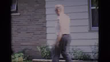 Clarkdale Arizona (1966): Man Walking On Front Lawn Is Greeted By His Dog On A