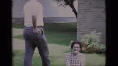 Clarkdale Arizona (1966): A Man And Woman Are Outside A Brick House Playing With A