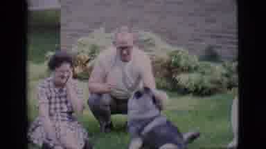 Clarkdale Arizona (1966): A Man Playing With A Dog Over Grass With He Is With Her