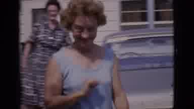 Clarkdale Arizona (1966): Woman In Blue Wags Finger At Camera And Walks Around