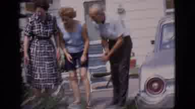 Clarkdale Arizona (1966): Adults Gathered Around Small Dog Picked Up By Man