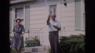 Clarkdale Arizona (1966): Three People By House With One Of Them Hosing The Grass