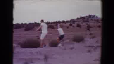 Flagstaff Arizona USA (1967): Boy Wearing Blue Shorts Pushes Teen Wearing Tan