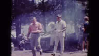 Flagstaff Arizona USA (1967): Two Men At A Barbecue Walking Away From Other People