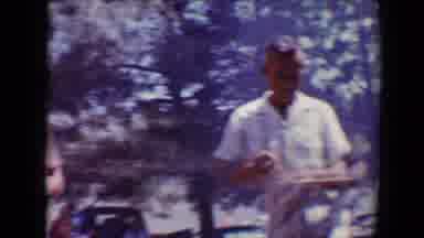 Flagstaff Arizona USA (1967): Men Walking And Holding Plates Of Food While Smiling
