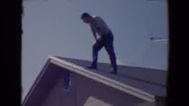 Flagstaff Arizona USA (1967): A Man Standing On The Roof Of His Home Overlooking