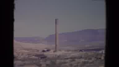Flagstaff Arizona USA (1967): Smokestack Towering Above Small Buildings In Desert