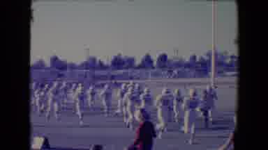 Tucson Arizona USA (1967): A Football Team Is Running On The Field As Spectators