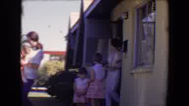 Tucson Arizona USA (1967): Men Women And Children Exiting A Yellow House On A
