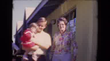 Tucson Arizona USA (1967): A Man Carries A Little Girl In A Red Dress While A