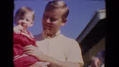 Tucson Arizona USA (1967): A Man Carries A Little Girl In His Arms And Talks To