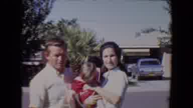 Tucson Arizona USA (1967): Man And Woman Stand Outside Holding A Baby Posing For A