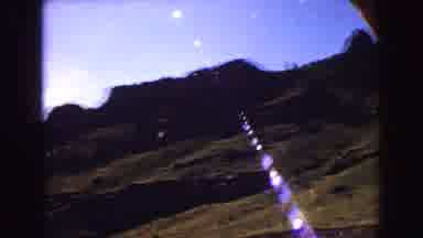 Yellowstone Wyoming USA (1967): A White Car In A Landfill Around Hills And Green