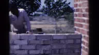 Cottonwood Arizona (1968): Man Stands Outside In The Sun Building A Brick Wall