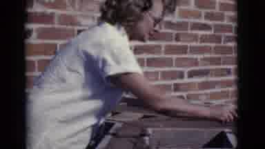 Cottonwood Arizona (1968): A Middle Aged Woman With Glasses Smooths Out A Cement