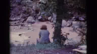 Cottonwood Arizona (1968): Woman Wearing Blue Shirt Sits Next To Tree By Pond On A