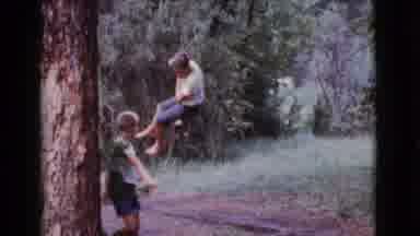 Cottonwood Arizona (1968): Boy Wearing White Shirt Swings On Rope Swing On A Clear
