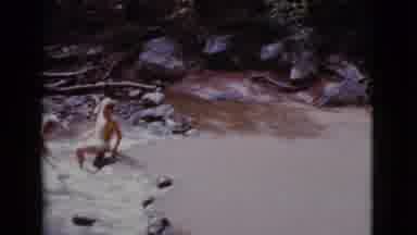 Cottonwood Arizona (1968): Two Boys Playing On A River Near Rocks And Big Sticks