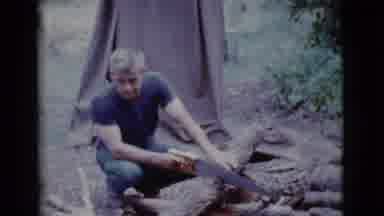 Cottonwood Arizona (1968): Man Wearing Blue Shirt Bows In Front Of Brown Tent On A