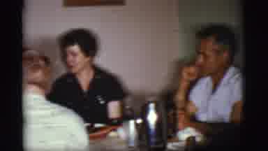 Cottonwood Arizona (1968): Couple Plays With Dog After Family Meal In The Dining