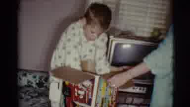 Cottonwood Arizona (1968): Boy In Pajamas Opening A Box Of Toys By Tv And Window