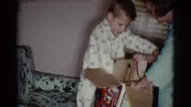 Cottonwood Arizona (1968): Boy Removes Toy From Box Helped By His Mother On Party