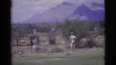 Cottonwood Arizona (1968): A Woman Bending Down To Get A Stick To Throw For A Dog