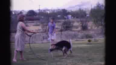 Cottonwood Arizona (1968): Woman And Her Children Play Outside With The Hose Pipe