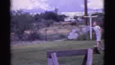 Cottonwood Arizona (1968): Woman Sprays The Hose As The Dog Chases The Water And