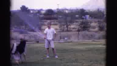 Cottonwood Arizona (1968): Kid Spouting Water Through The Hose And Playing With