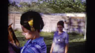 Cottonwood Arizona (1968): Woman Wearing Yellow Hair Ribbon Puts Blanket On Brown