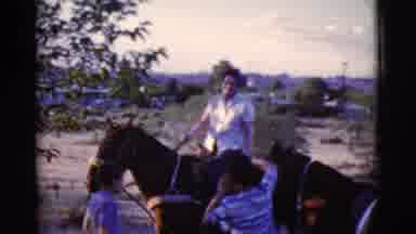 Cottonwood Arizona (1968): A Person Is Riding A Horse At A Stable With Other