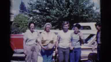 Cottonwood Arizona (1968): Five People Standing In Front Of Brown Car On A Bright