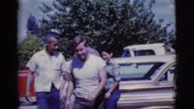 Cottonwood Arizona (1968): A Small Group Of People Walk Past Each Other Near Cars