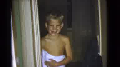 Cottonwood Arizona (1968): A Blond Haired Boy Smiling Brightly In A Doorway Of A