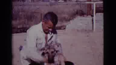 Cottonwood Arizona (1968): Man With Cigarette Washing Dog In Red Barrel