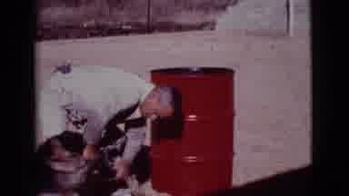 Cottonwood Arizona (1968): Man Standing Next To Red Drum Scratches German Shepherd