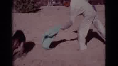 Cottonwood Arizona (1968): Man In Overalls Chases Dog Around The Yard With A Towel