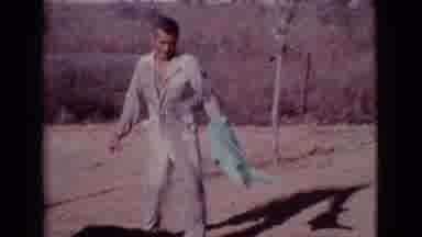 Cottonwood Arizona (1968): Man Outside Holding A Green Towel Who Is Wearing A