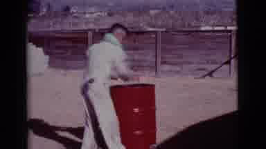 Cottonwood Arizona (1968): Man Wearing White Jumpsuit Walks Away From Red Barrel